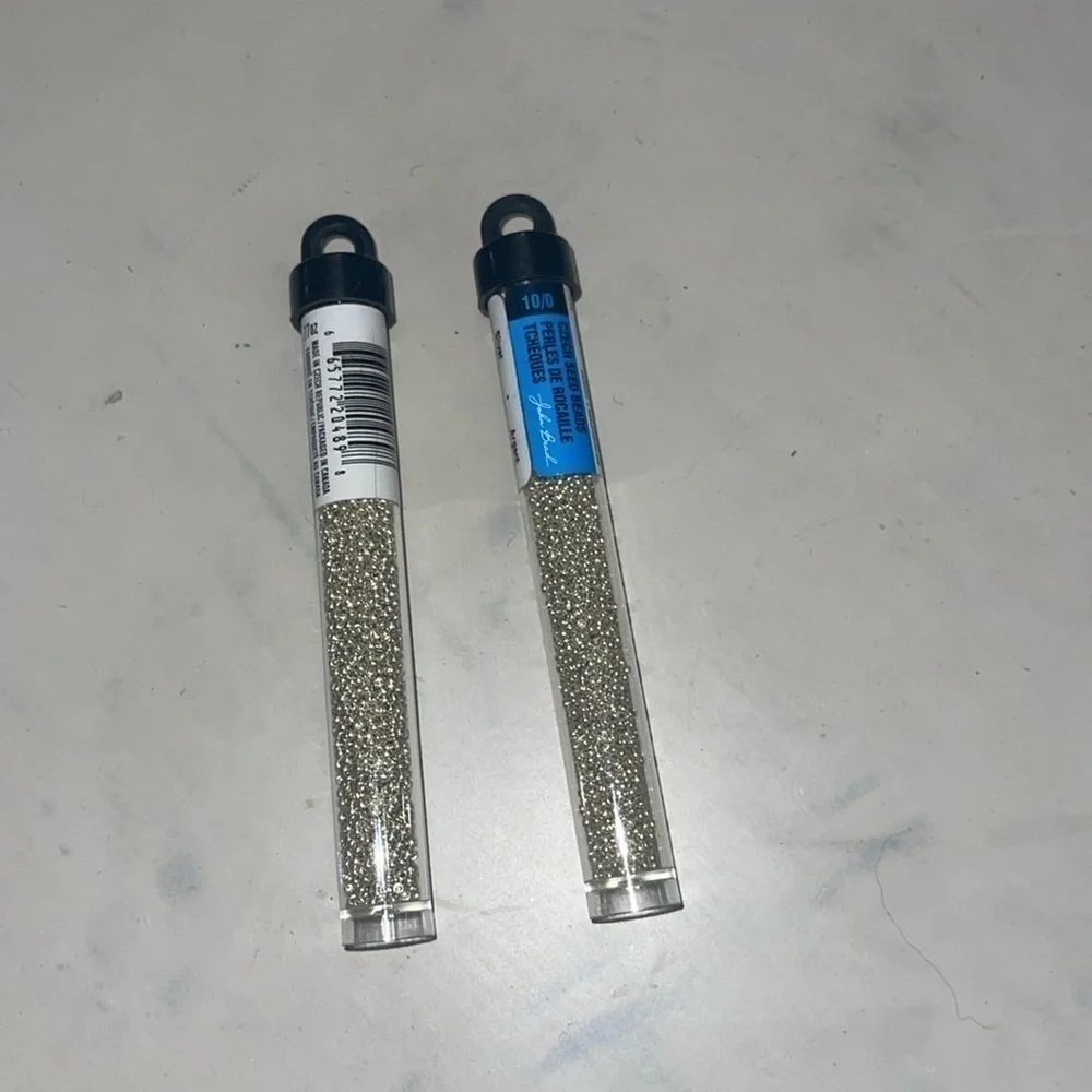 Silver beads in glass one open the other unopened great for jewelry